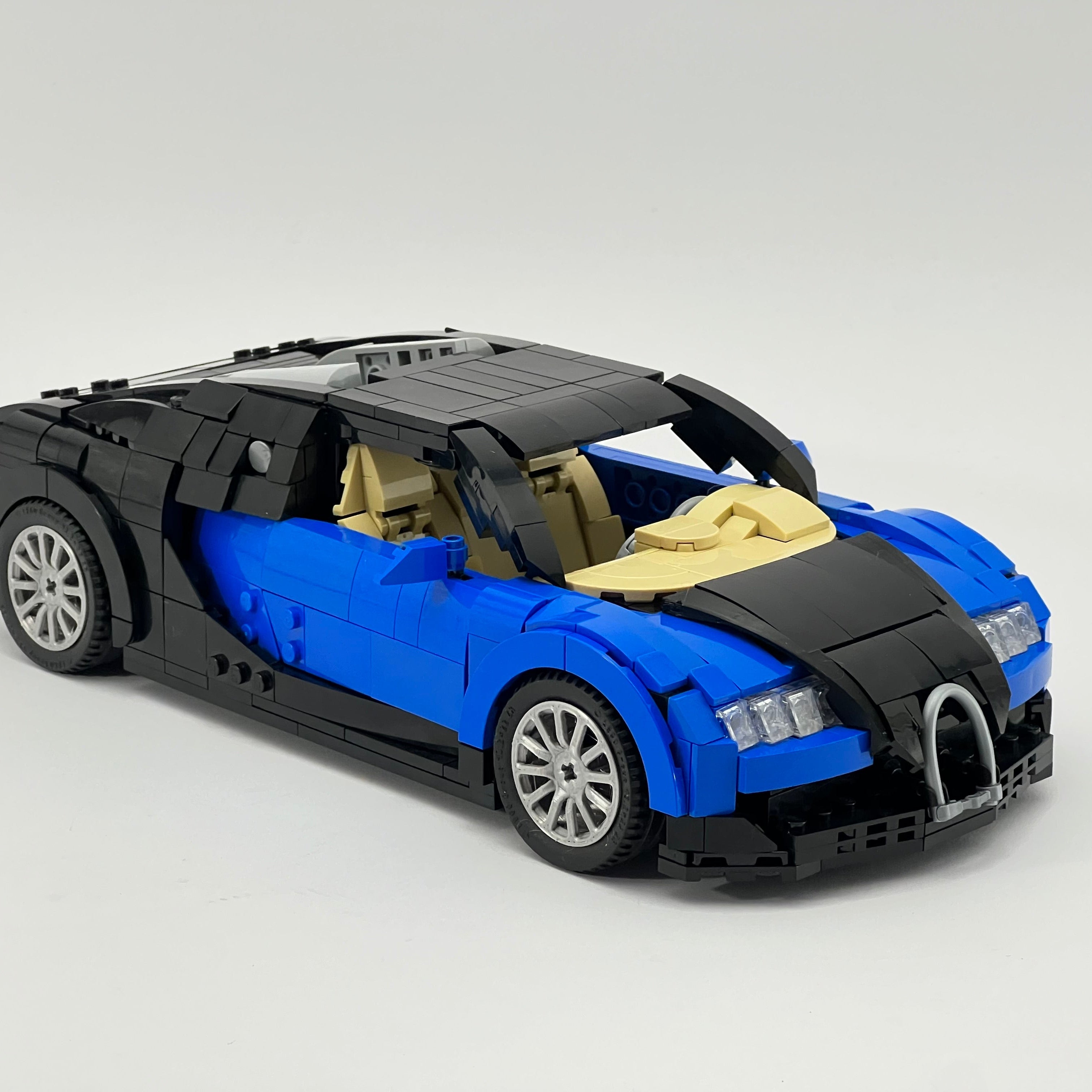 Blue and black toy car model on a light gray background